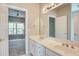 Bathroom featuring double sinks, a large mirror, and neutral color scheme at 3015 Larkspur Ct, Cumming, GA 30041