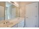 Bright bathroom with a double sink vanity, neutral walls and a large mirror at 3015 Larkspur Ct, Cumming, GA 30041