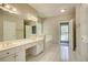 Bright bathroom with a dual vanity, white tile floors, and separate tub at 3015 Larkspur Ct, Cumming, GA 30041