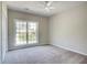 Bedroom with neutral walls, carpet and a large window with backyard views at 3015 Larkspur Ct, Cumming, GA 30041