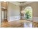 Elegant dining room featuring hardwood floors, wainscoting and a large window with backyard views at 3015 Larkspur Ct, Cumming, GA 30041