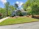 Beautiful home with a well-manicured lawn, stone details and lush surrounding greenery at 3015 Larkspur Ct, Cumming, GA 30041
