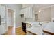 Open kitchen features white cabinets, a breakfast bar, and hardwood floors at 3015 Larkspur Ct, Cumming, GA 30041