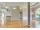 Open-concept living room with hardwood floors, columns, and a view of the dining area at 3015 Larkspur Ct, Cumming, GA 30041