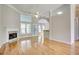 Open-concept living room featuring hardwood floors and fireplace at 3015 Larkspur Ct, Cumming, GA 30041