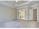 Large main bedroom with tray ceilings and french doors to a spa-like bathroom at 3015 Larkspur Ct, Cumming, GA 30041