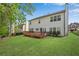 Well-manicured backyard with a deck and mature trees creating a private outdoor space at 3925 Tugaloo River Dr, Duluth, GA 30097