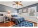 Teen bedroom with gray and navy walls, wood floors, and wainscoting at 4765 Karls Gate Dr, Marietta, GA 30068