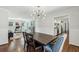 Open dining area with hardwood floors, a modern light fixture, and an open view to the kitchen and living room at 4765 Karls Gate Dr, Marietta, GA 30068