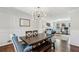 The dining room features hardwood floors, stylish lighting, and is adjacent to the living area at 4765 Karls Gate Dr, Marietta, GA 30068