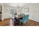Elegant dining room with hardwood floors, wainscoting, and a modern chandelier at 4765 Karls Gate Dr, Marietta, GA 30068