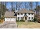 Beautiful two-story home with a two-car garage, landscaped yard, and classic facade with gray shutters at 4765 Karls Gate Dr, Marietta, GA 30068