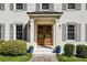 Elegant double front doors with decorative columns, sidelights, and well-maintained landscaping at 4765 Karls Gate Dr, Marietta, GA 30068