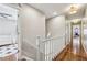 Second floor hallway with light gray walls, hardwood floors, white banister and views into bedrooms at 4765 Karls Gate Dr, Marietta, GA 30068