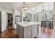 Open kitchen with a gray island, stainless steel appliances, and sunroom access at 4765 Karls Gate Dr, Marietta, GA 30068