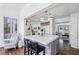 Open kitchen with a gray island, stainless steel appliances, and sunroom access at 4765 Karls Gate Dr, Marietta, GA 30068