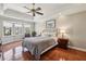 Relaxing main bedroom featuring tray ceiling, bay window, and hardwood flooring at 4765 Karls Gate Dr, Marietta, GA 30068