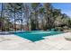 Community pool covered for the off-season, surrounded by mature trees and ample deck space at 4765 Karls Gate Dr, Marietta, GA 30068