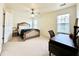 Bedroom featuring a comfortable bed, desk, and natural light from a large window at 5401 Fox Creek Lane, Norcross, GA 30071