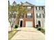 Charming townhome with a well-maintained brick facade, lush greenery, and a spacious driveway at 5401 Fox Creek Lane, Norcross, GA 30071