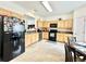 Eat-in kitchen features light wood cabinets, modern appliances, and plenty of counter space for cooking at 5401 Fox Creek Lane, Norcross, GA 30071