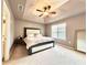 Spacious bedroom with a large bed, tray ceiling with fan, and ample natural light at 5401 Fox Creek Lane, Norcross, GA 30071
