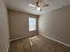 Neutral bedroom features carpet, a ceiling fan, and a window that lets in natural light at 5820 Wellborn Oaks Ct, Lithonia, GA 30058