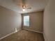Neutral bedroom features carpet, a ceiling fan, and a window that lets in natural light at 5820 Wellborn Oaks Ct, Lithonia, GA 30058