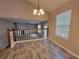 Dining room overlooking living room and featuring chandelier and new flooring at 5820 Wellborn Oaks Ct, Lithonia, GA 30058
