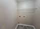 Functional laundry room features a wire shelf for storage and convenient hookups for your appliances at 5820 Wellborn Oaks Ct, Lithonia, GA 30058