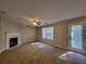 Living room featuring a fireplace, ceiling fan, and access to outdoor patio at 5820 Wellborn Oaks Ct, Lithonia, GA 30058