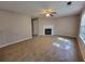 Comfortable living room featuring carpet floors, a fireplace, and lots of natural light at 5820 Wellborn Oaks Ct, Lithonia, GA 30058