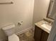 Half bathroom with vinyl flooring, a single sink vanity with granite countertop, and white toilet at 234 Gamel Rd, Dallas, GA 30157