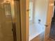 Bathroom with glass shower, garden tub, and window at 234 Gamel Rd, Dallas, GA 30157