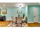 Elegant dining area featuring a round wood table and a statement roman numeral clock at 3620 Spring Trce, Decatur, GA 30034