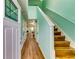 Inviting entryway featuring sleek wood flooring, calming paint and stairs to the upper level at 3620 Spring Trce, Decatur, GA 30034