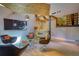 Cozy basement with unique seating, an entertainment area with custom bar, hardwood floors, and industrial-chic design elements at 151 Rockmart Dr Sw, Atlanta, GA 30314