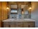 Modern bathroom with double sink vanity, marble countertop, decorative mirror and sconce lighting at 151 Rockmart Dr Sw, Atlanta, GA 30314
