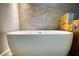 This luxurious bathroom has a freestanding tub and unique accent tile at 151 Rockmart Dr Sw, Atlanta, GA 30314