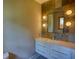 Bright bathroom featuring natural stone accent wall with modern vanity and mirror at 151 Rockmart Dr Sw, Atlanta, GA 30314