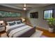 Bedroom with modern decor, large windows, and a television mounted on the wall at 151 Rockmart Dr Sw, Atlanta, GA 30314