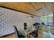 Stylish dining room with a modern table set on hardwood floors, textured wall, and unique lighting fixtures at 151 Rockmart Dr Sw, Atlanta, GA 30314