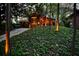 Modern brick home with landscape lighting nestled among mature trees and foliage at 151 Rockmart Dr Sw, Atlanta, GA 30314
