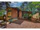 Brick home with modern design featuring large windows, a wooden walkway, and a landscaped yard at 151 Rockmart Dr Sw, Atlanta, GA 30314