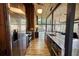 Gourmet kitchen featuring stainless steel appliances, granite countertops, custom cabinets, and hardwood floors overlooking living room at 151 Rockmart Dr Sw, Atlanta, GA 30314