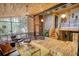 Open concept living area with hardwood floors, a modern railing, and a wall of windows offering views of the surrounding nature at 151 Rockmart Dr Sw, Atlanta, GA 30314