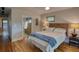 Relaxing main bedroom features hardwood floors, and a modern headboard, and ensuite bathroom at 151 Rockmart Dr Sw, Atlanta, GA 30314
