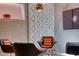 Chic sitting area featuring modern furniture, unique 3D wall panels, and contemporary lighting fixtures for a stylish ambiance at 151 Rockmart Dr Sw, Atlanta, GA 30314