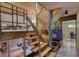 Unique staircase design featuring wooden treads, a blue tiled water feature, and modern railing at 151 Rockmart Dr Sw, Atlanta, GA 30314
