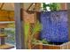 Close-up view of the blue tiled water feature, lush plants, and architectural wood accents at 151 Rockmart Dr Sw, Atlanta, GA 30314